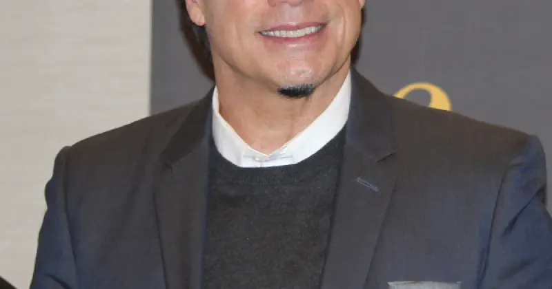 John Travolta at Cannes Film Festival with his iconic new look — beret, glasses, and full beard